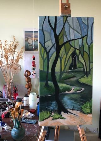 Judy Randle's easel in her studio, paints, paint brushes and partly finished acrylic painting on the easel